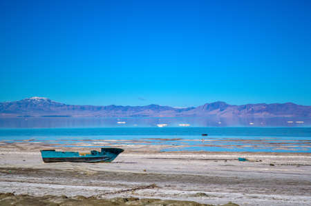 Abandoned rusty boat on the salty shore of the Urmia Lake in Iranの写真素材