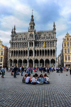 Brussels, Belgium - July 13, 2019: A group of young travelers sitting on the central square of Brussels, Belgium, known as the Grand Placeのeditorial素材