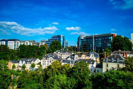 Luxembourg city, Luxembourg - July 15, 2019: Typical old buildings in contrast with modern glass buildings against blue sky in Luxembourg city on a summer dayのeditorial素材