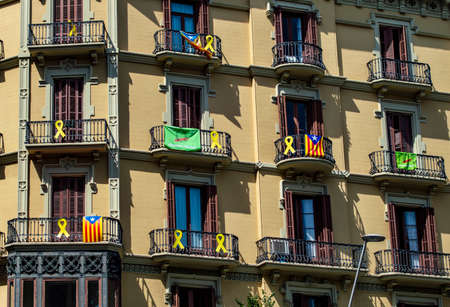 Barcelona, Spain - July 24, 2019: Catalan flags and protest ribbons on balconies of a building in the city of Barcelona, Catalonia, Spainのeditorial素材