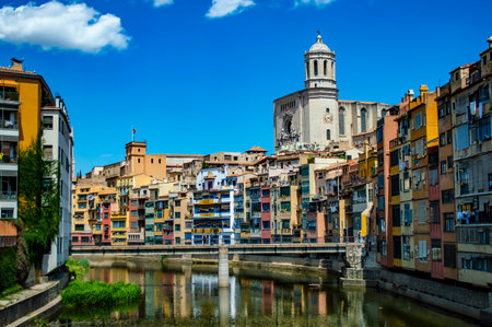 Girona, Spain - July 28, 2019: Saint Mary Cathedral and colorful riverside houses of the Jewish quarter in the city of Girona, Catalonia, Spainのeditorial素材