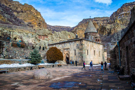 Geghard, Armenia - January 17, 2021: Tourists in the inner yard of the Geghard monastery in Armeniaのeditorial素材