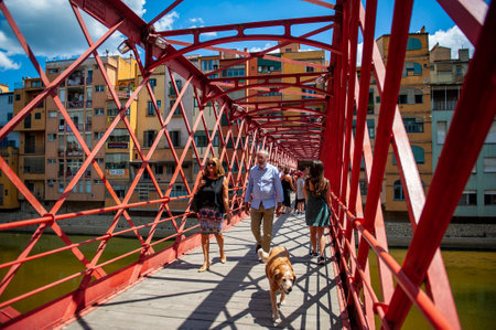 Girona, Spain - July 28, 2019: Tourists walking on the famous Eiffel Bridge in the city of Girona, Spainのeditorial素材