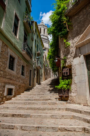 Girona, Spain - July 28, 2019: Beautiful limestone stairs in the Jewish quarter of the city of Girona, Catalonia, Spain.のeditorial素材