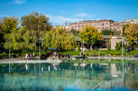 Yerevan, Armenia - October 31, 2019: People walking around the Swan Lake in Yerevan, Armeniaのeditorial素材
