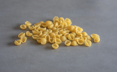 Shell-like pasta spread on a gray surface