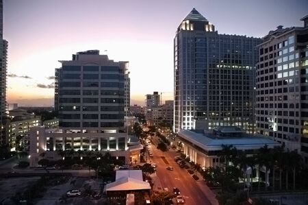 Cityscape at dusk with office buildings and light traffic on Las Olas Boulevard in Fort Lauderdale, Florida.の写真素材