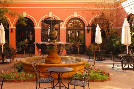 Courtyard with beautiful fountain, plants and arches with spanish atmosphere.の写真素材