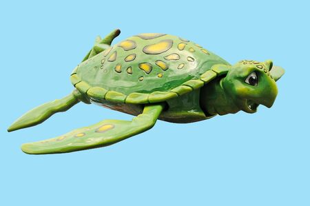A cute green turtle with a blue background.の写真素材