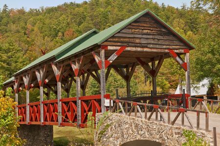 Covered Bridge with a backdrop of Fall Colors near Teleco Plains, North Carolina in the Smoky Mountains.の写真素材
