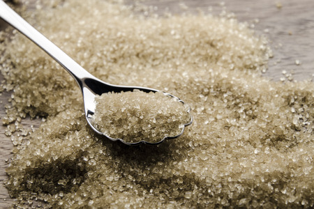 brown cane sugar with silver spoonの写真素材