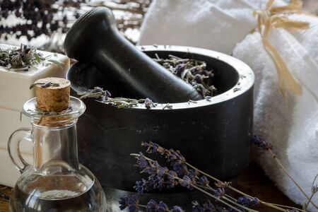 grinding and crushing of dried lavender with a stone mortarの写真素材