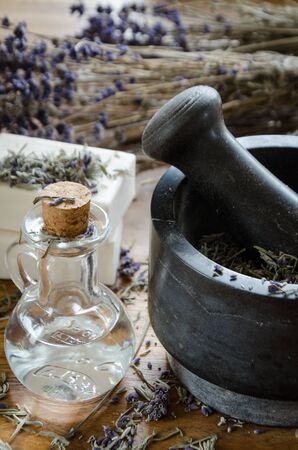 grinding and crushing of dried lavender with a stone mortarの写真素材