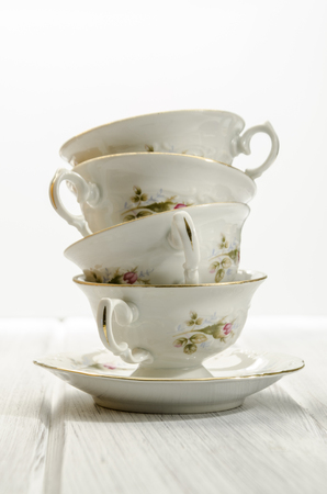 two stylish antique teacups on white backgroundの写真素材