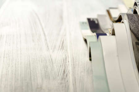 stack of magazines on a white-painted wooden table