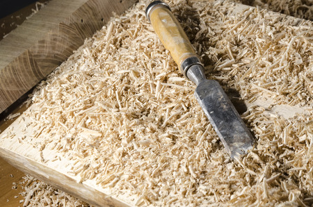 joinery tools - chisel on wooden table with sawdust