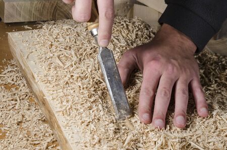 joinery tools - chisel on wooden table with sawdustの写真素材