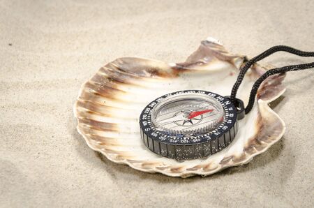 compass pointing the way to the sand lost wandererの写真素材