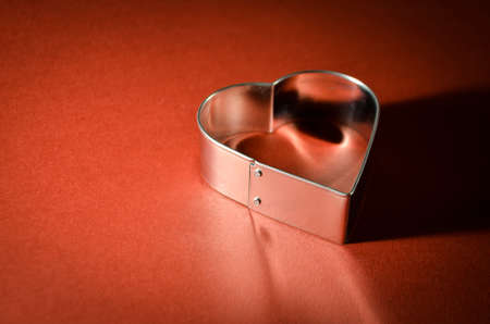 Velentines Card with heart shape on vivid red backgroundの写真素材