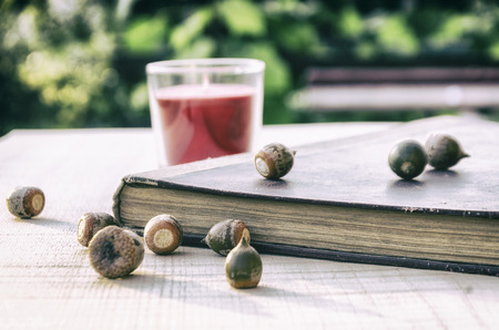 stack of old books on a wooden table in the gardenの写真素材