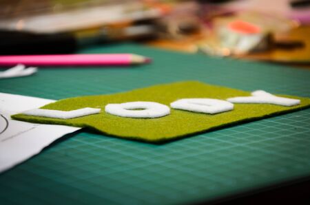 Manual cutting letters with colored sheets of feltの写真素材