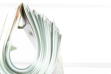 side view of a stack of magazines with glossy paperの写真素材