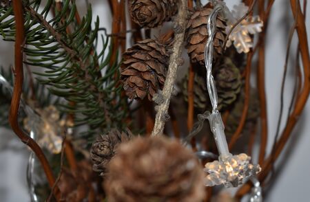 Christmas Decorated with Lights and Cones on White Backgroundの写真素材