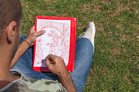 a young designer working on his sketchの写真素材