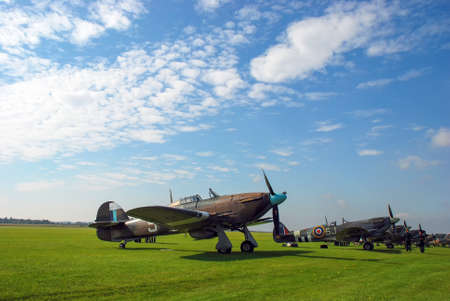 RAF fighter aircraft from the Battle of Britain era parked at an airfield