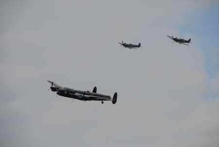 The RAF's iconic Avro Lancaster heavy bomber escorted by Supermaine Spitfires