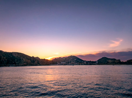 The colours of a Pacific sunset over the resort of Cabo San Lucas in Baja California, Mexicoの写真素材