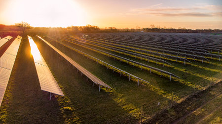 The early morning sun reflects off the panels of a solar farm in Suffolk, UK