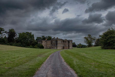 Storm clouds over Calke Abbey in Derbyshire, UK