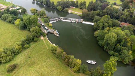 An aerial view of the weir on the River Thames at Mapledurham in Oxfordshire, UKのeditorial素材