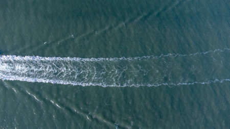 An aerial view of a lone boat on a river in Suffolk, UKの写真素材