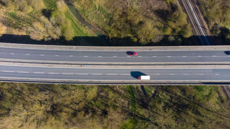 A high angle view of traffic on a dual carriageway passing next to Stowmarket in Suffolk, UKの写真素材