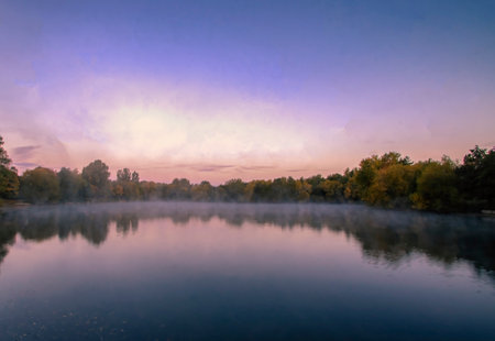 Early morning mist over a lake in Needham Market, Suffolk, UKの写真素材