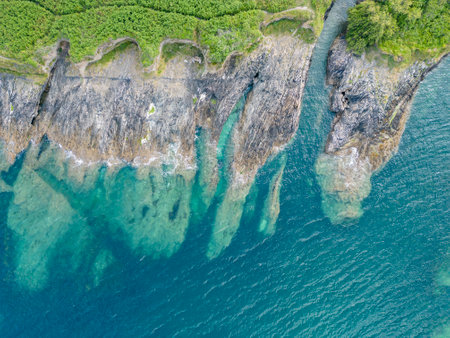 An aerial view looking down at the rocky coast of Pendennis Point near Falmouth, Cornwall, UK