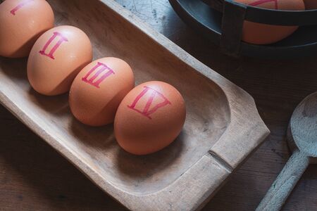 Do not count your chickens before they hatch . concept .eggs in home made wooden bowl  with wooden...