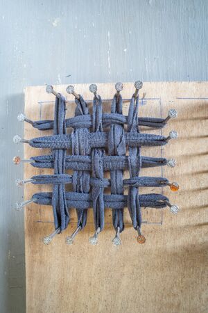 odd sock cut up on tawashi loom  ,for making Tawashi.flat lay,room for text.の写真素材