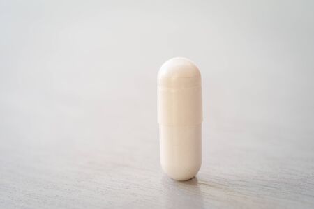 Magnesium citrate white capsules close up with room for text.