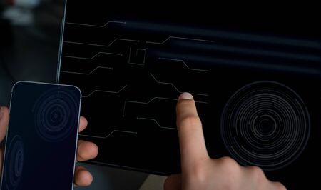 close up hi tech tablet & cell phone with hands.futurist hud display. 4G, 5G technology.の写真素材