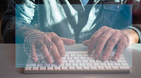 male computer hacker or developer using a keyboard with a virtual screen.concept hi tech hacker...