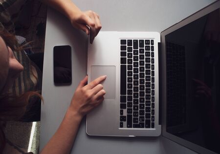 shopping online with laptop using credit card at home woman holding credit card and using laptop. Online shopping ordering takeaway duding lockdown covid 19 conceptの写真素材