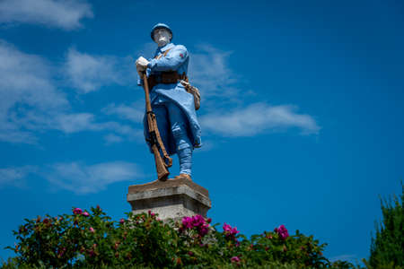 war memorial for the men lost in the first world war, statue of a blue soldier. lozere, France.の写真素材