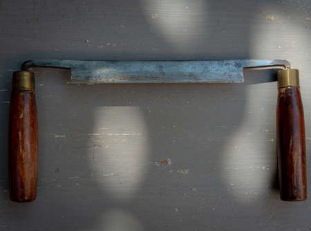 old spoke shave on a gray painted table, hobby or pastime. diy at home