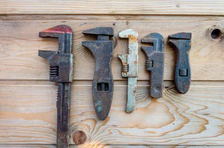old adjustable spanners on wooden table, vintage tools. labor day.の写真素材