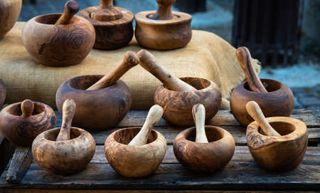 a selection of wooden mortar and pestle made from olive wood on market stall provence France.の写真素材