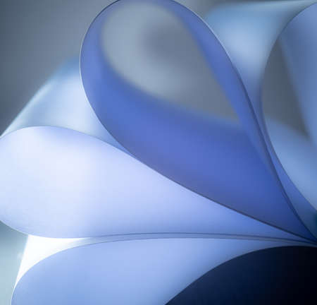 close up abstract with bent paper background, selective focus; blue color.