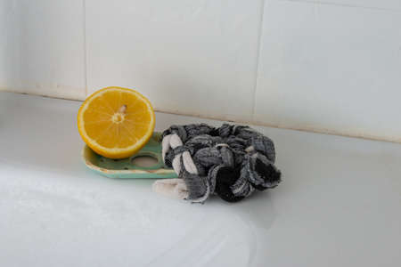 Tawashi reusable sponge and cut lemon in bathroom for cleaning zero waste .eco freindly.